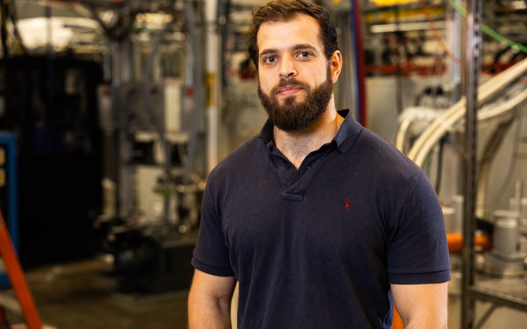 MIT's Proto Ventures fellow Theo Mourtaditis in front of a industrial machine shop inside MIT